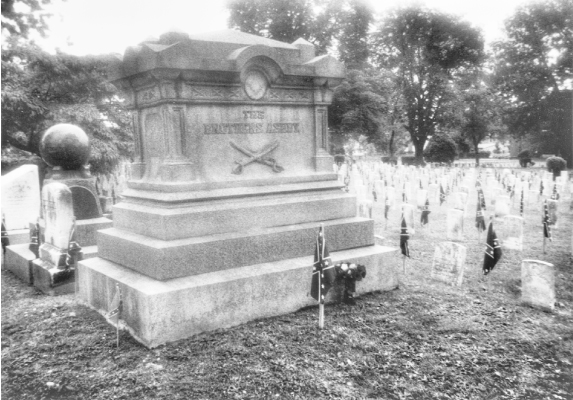 This photograph was taken in Stonewall Confederate Cemetery, Winchester, Virginia, on June 7, 2001, the day after the observance of Confederate Memorial Day, which is celebrated in Winchester on June 6, the anniversary of General Turner Ashby's death in battle in 1862. As Cather mentions in the epilogue to Sapphira and the Slave Girl, Ashby's large tomb (inscribed THE BROTHERS ASHBY) is decorated with flowers, and all the graves in the cemetery are decorated with small Confederate flags. One of the small adjacent tombstones marks the grave of Willa Cather's uncle, James William Boak.