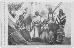 Native American women and children in front of tipis