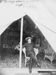 William F. Cody sits in doorway of tent