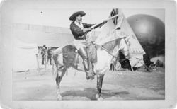 William F. Cody on horse with rifle on backlot of Buffalo Bill's Wild West