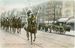 Native American men wearing traditional regalia riding on horses