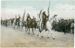 Native American men in traditional regalia on horseback