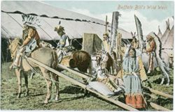 Native American men on horseback with a child on a travois