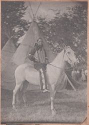 High Heron, Sioux Indian performer in Buffalo Bill's Wild West, tipi behind