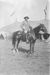 William F. Cody on horseback on backlot of Buffalo Bill's Wild West