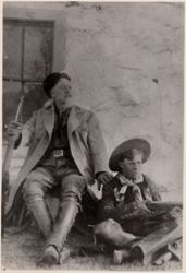 William F. Cody and Carl Downing sit holding rifles