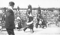 Five Native Americans and one non-Indian walk along roadway