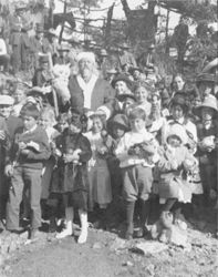 William F. Cody as Santa Claus standing with group of children near Oracle, Arizona