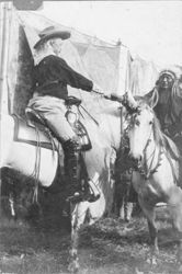 William F. Cody and Native American man shaking hands on horses