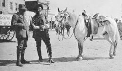 William F. Cody and Prince of Monaco standing next to white horse in Cody, Wyoming