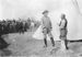 William F. Cody speaking with Native American man beside tipi