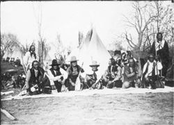 Native American men sitting holding pipes