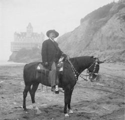 William F. Cody on dark horse near Cliff House